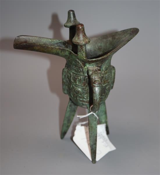 A Chinese archaistic bronze tripod vessel, jue, H. 29.5cm